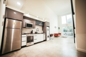 A kitchen with stainless steel appliances and a refrigerator.