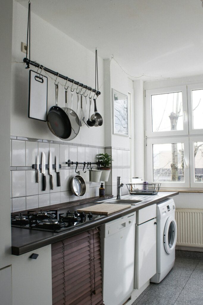 A white kitchen with a washer and dryer.