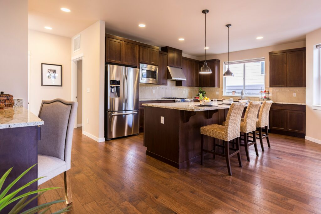 A kitchen with hardwood floors and a center island.