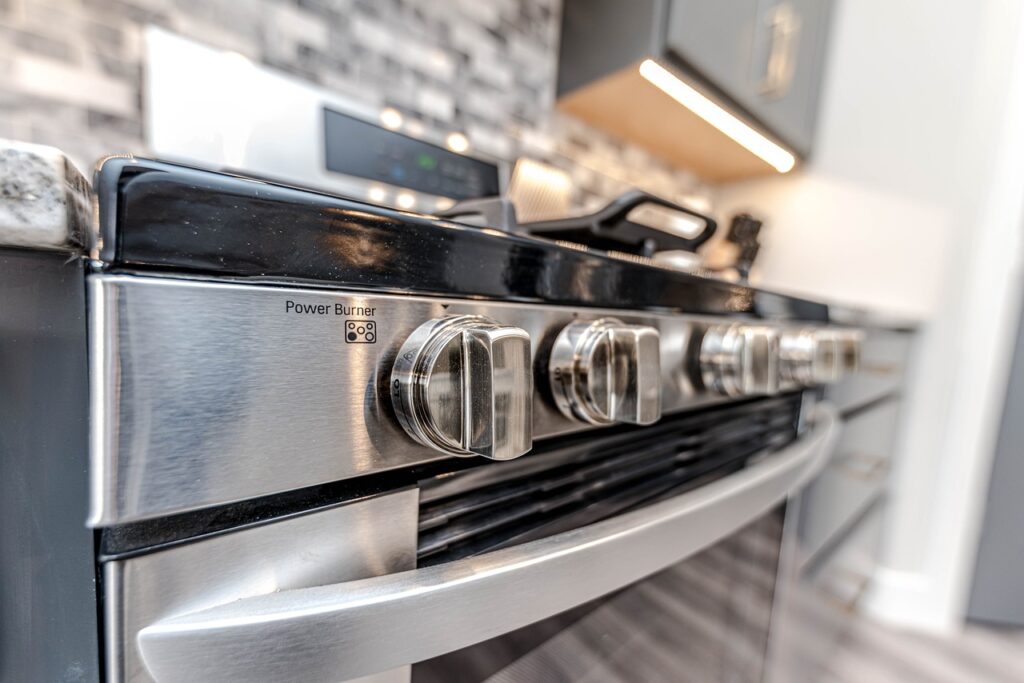 A stainless steel stove top in a kitchen.