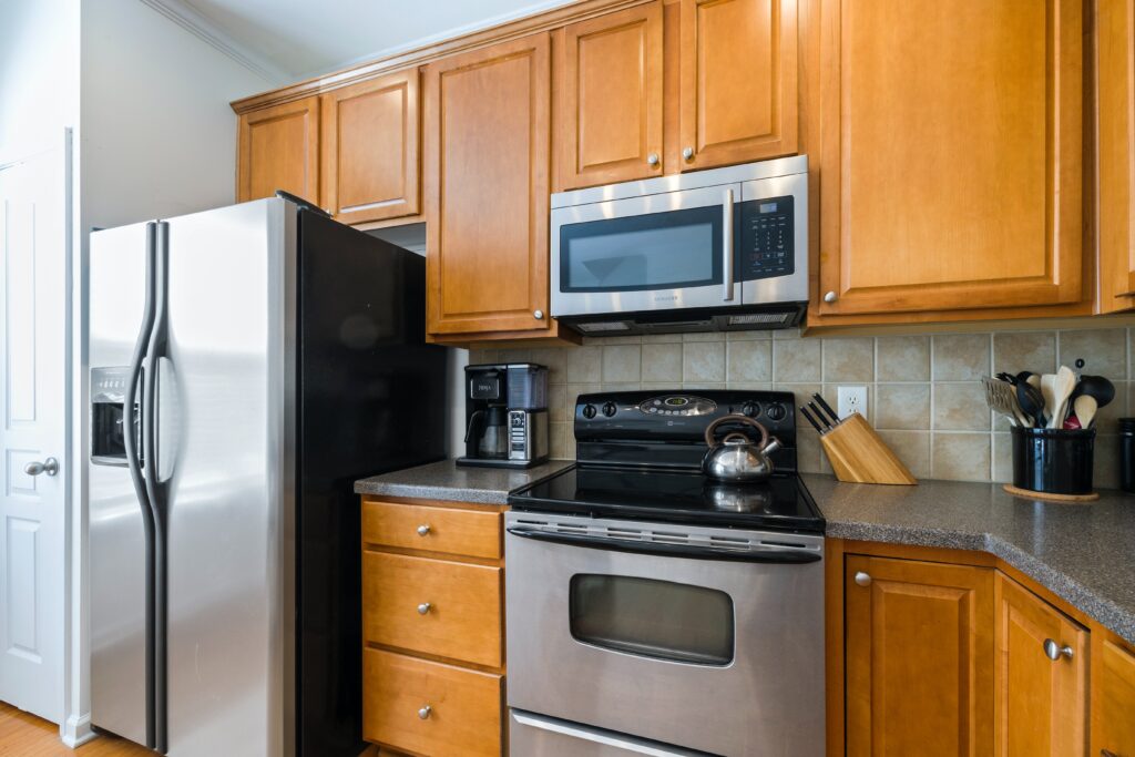 a kitchen with wooden cabinets and stainless steel appliances.