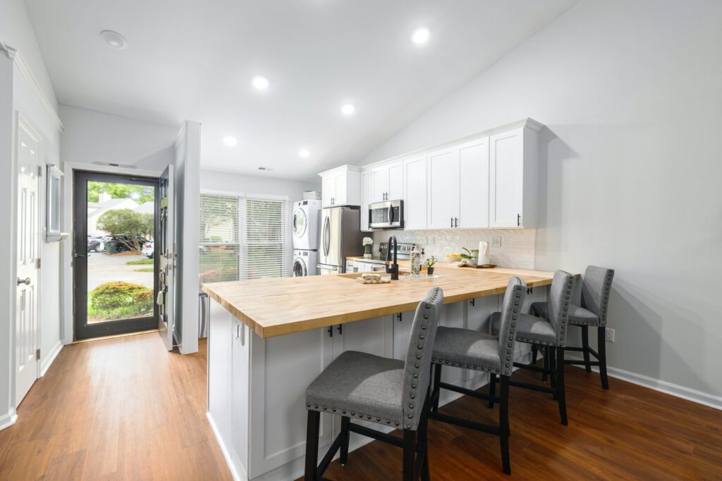 A kitchen with a counter and bar stools.