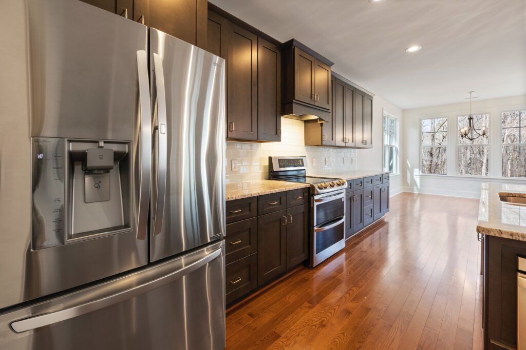 A kitchen with stainless steel appliances and hardwood floors.