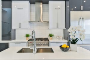 A white kitchen with stainless steel appliances.