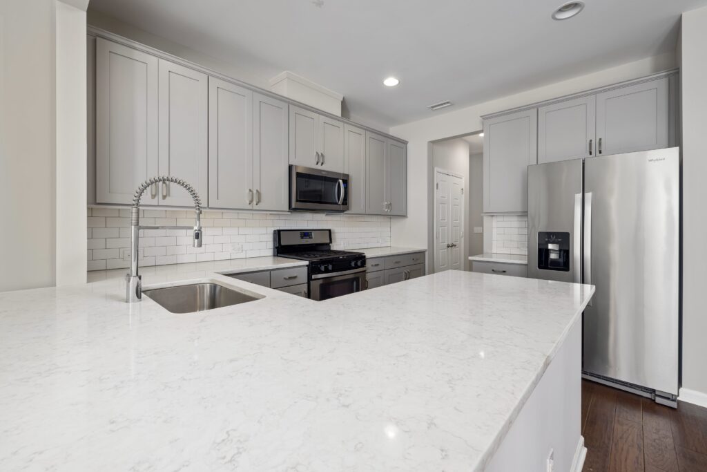 A kitchen with white cabinets and stainless steel appliances.