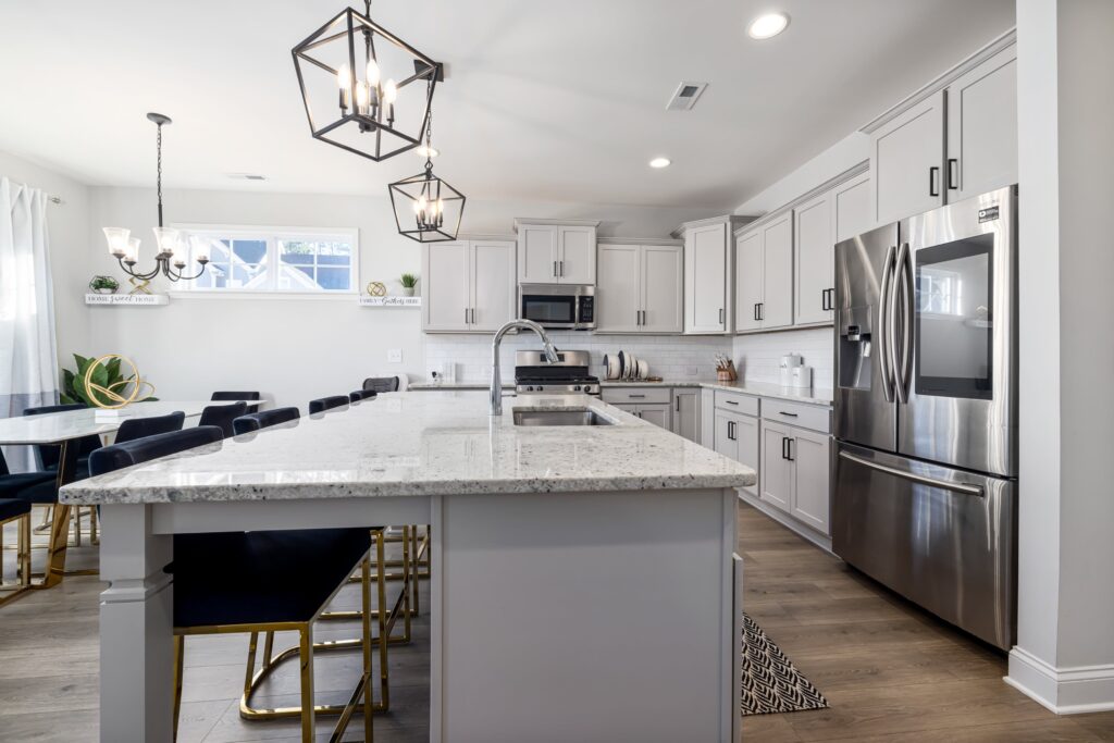 A kitchen with gray cabinets and stainless steel appliances.