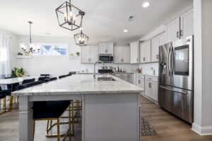 A kitchen with gray cabinets and stainless steel appliances.