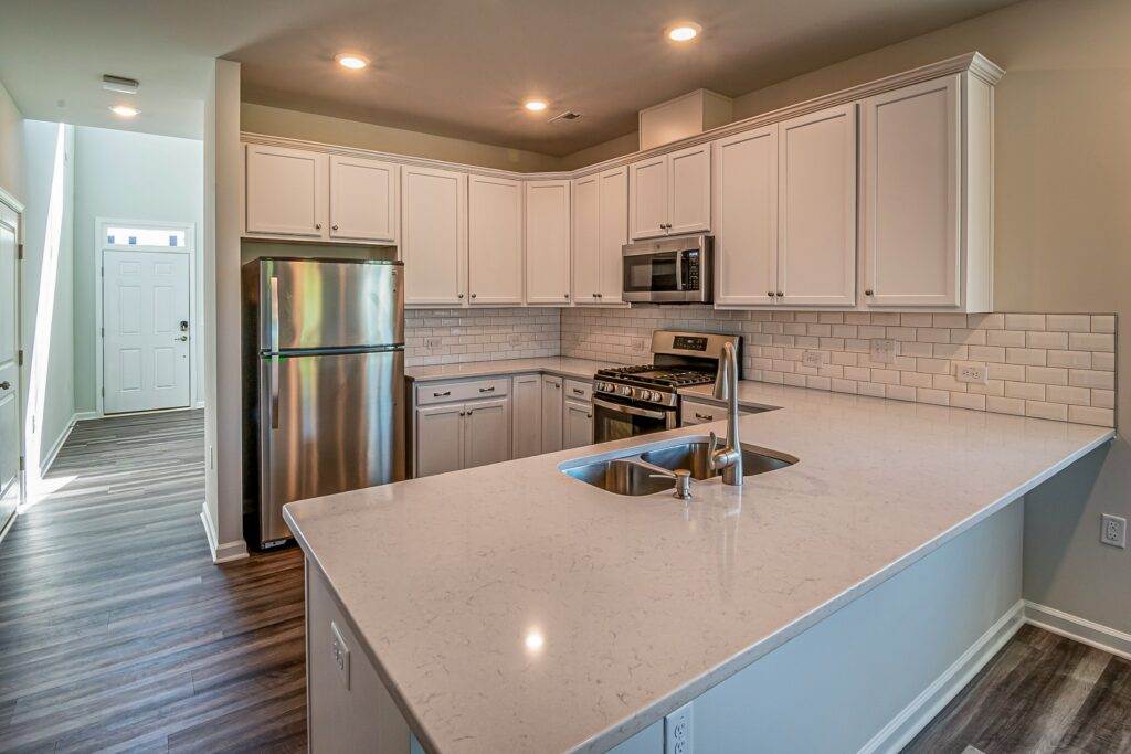 A kitchen with white cabinets and stainless steel appliances.