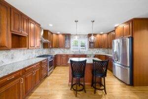 A kitchen with wood cabinets and granite counter tops.