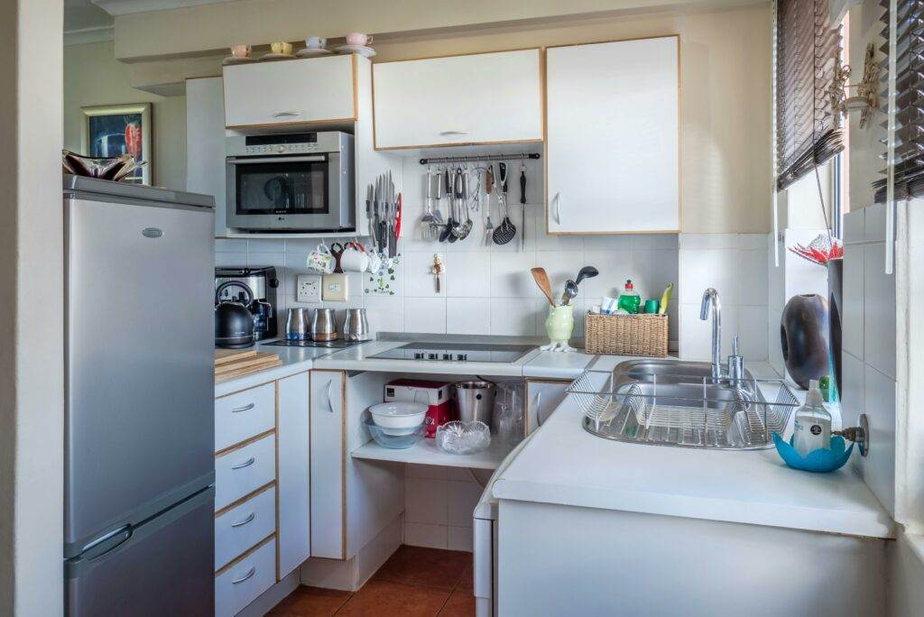 A small kitchen with a refrigerator and sink.
