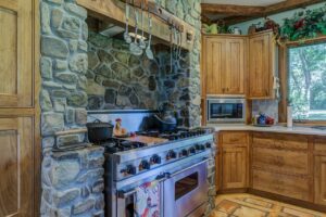a kitchen with stone counter tops and a stove.