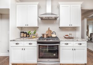 a white kitchen with a stove and oven.