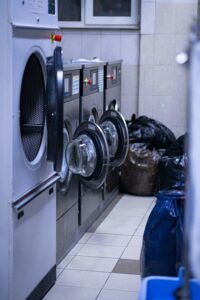 a row of washing machines in a laundry room.