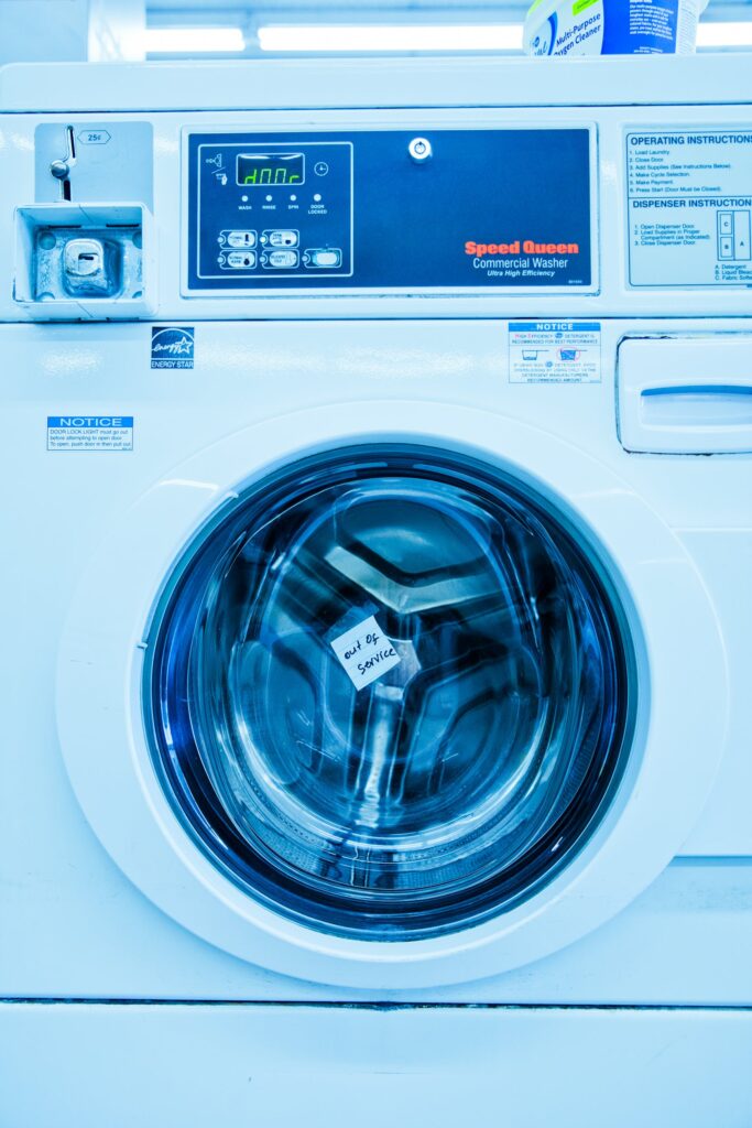 a white washing machine in a laundry room.