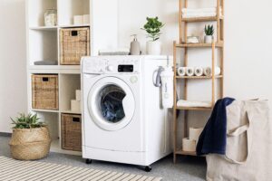 a laundry room with a washing machine and baskets.