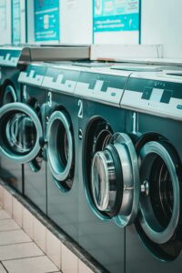 a row of washing machines in a laundry room.
