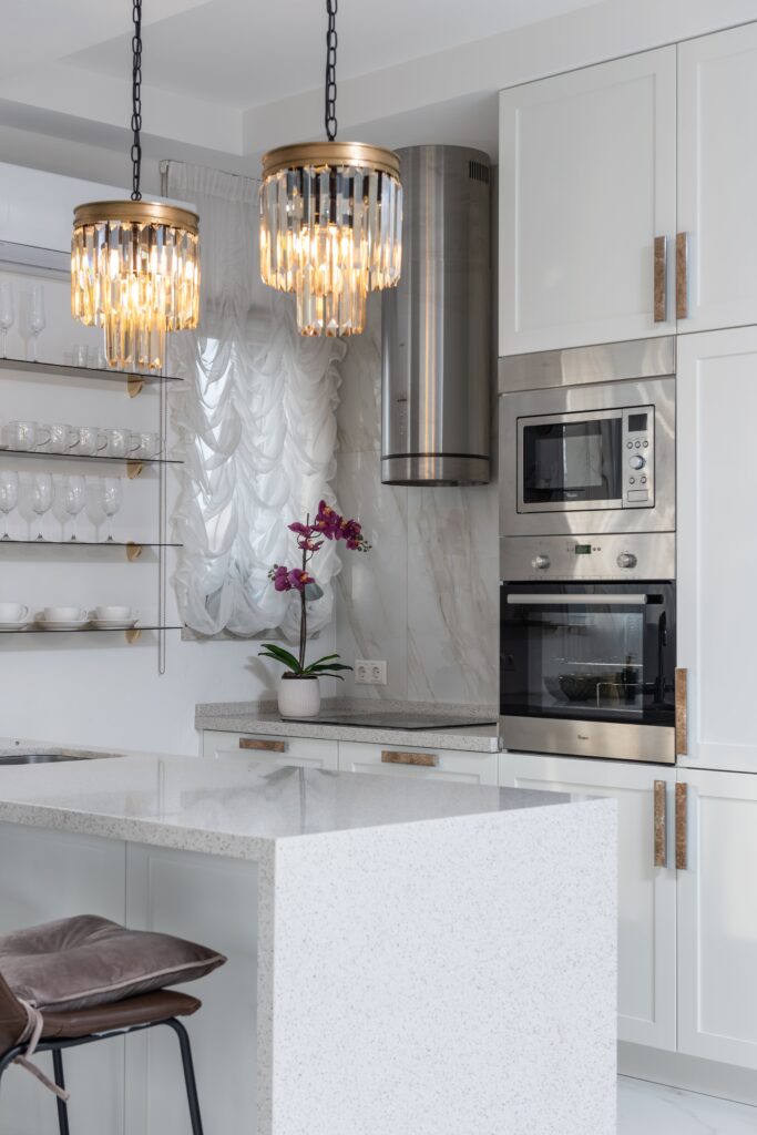 a white kitchen with a white island.