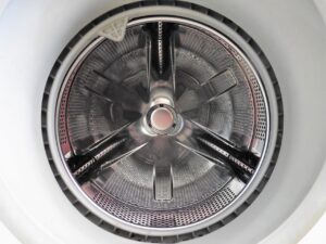 A close up of the wheel of a washing machine.