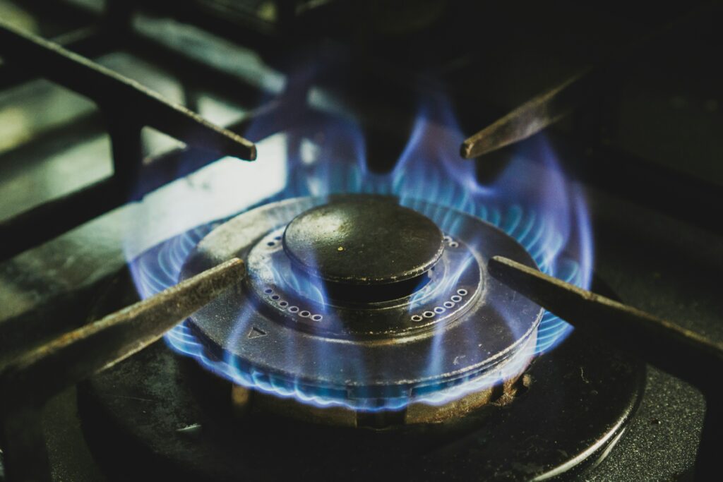 a close up of a gas stove with blue flames.
