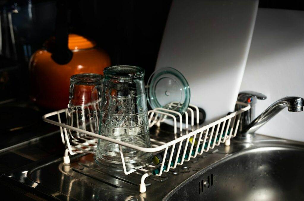 A kitchen sink with a dish rack on it.