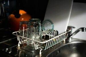 A kitchen sink with a dish rack on it.