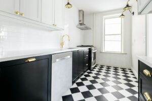 A kitchen with a black and white checkered floor.