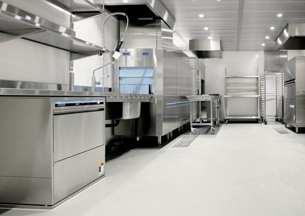 A large commercial kitchen with stainless steel appliances.