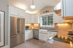 a kitchen with stainless steel appliances and white cabinets.