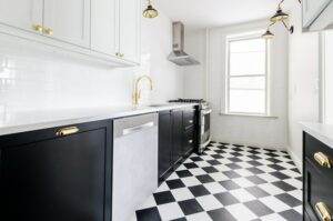 A kitchen with a black and white checkered floor.
