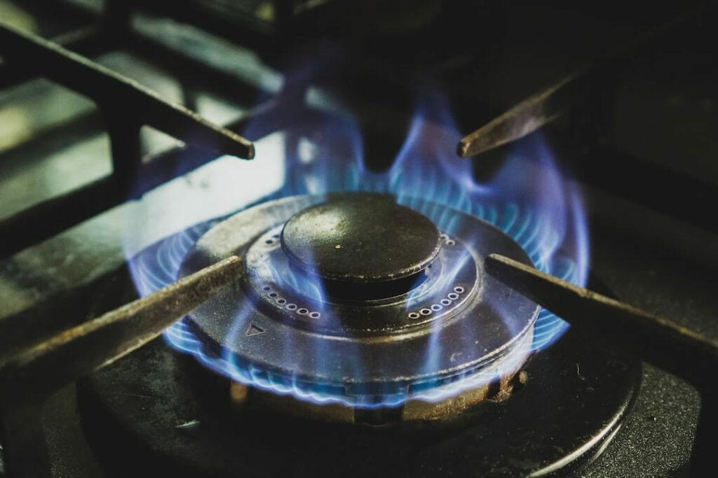 a close up of a gas stove with blue flames.