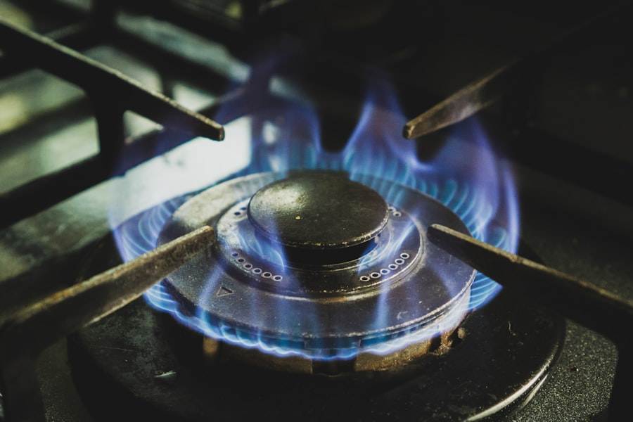 A close up of a gas stove with blue flames.
